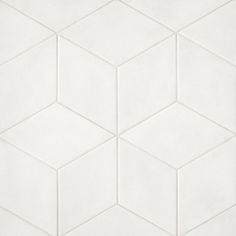 a white tiled wall with hexagonal shapes