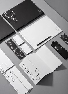 the stationery is laid out neatly on top of each other, including black and white paper