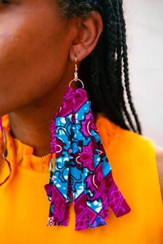 Make any outfit pop with our Ankara wax print earrings. Earrings come in three different lengths and in an assortment of colors. Be Bold and Brilliant as you in stand in your power with AfricaOnMyBack ear adornments. Disclaimer: Product color and quality seen may vary slightly compared to actual items due to photography lighting conditions and items being one-of-a-kind. Vegan Leather Backpack, Slouch Bags, Yoga Mat Bag, Mat Bag, Photography Lighting, Wax Print, Pencil Pouch, Black Boys, Fringe Earrings