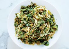 a white bowl filled with pasta and vegetables