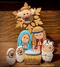 a nativity scene made out of wood and painted with different colored paint on it