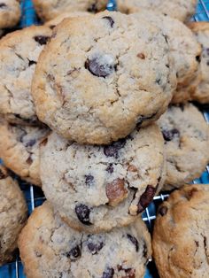 a pile of cookies sitting on top of a cooling rack