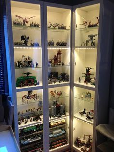 a display case filled with lots of toy figurines in it's glass doors