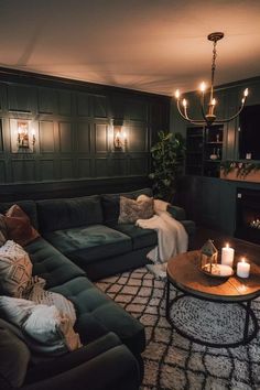 a living room filled with lots of furniture and candles on top of it's coffee table