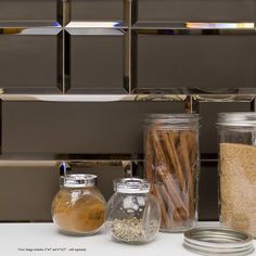 there are many jars and containers on the counter