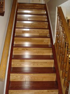 a wooden staircase with handrails and wood flooring