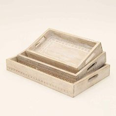 two wooden trays sitting on top of each other