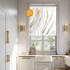 a kitchen with white cabinets and gold trim on the window sill above the sink