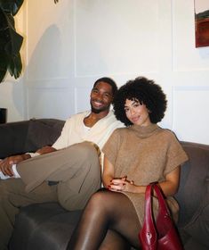 a man and woman are sitting on a couch