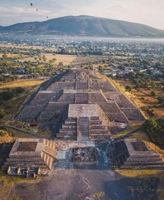 an aerial view of the ancient city of tempukit, with hot air balloons in the sky