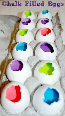 an egg carton filled with eggs painted in different colors and shapes, sitting on a table