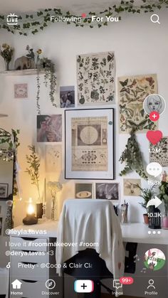 a room with many pictures and plants on the wall