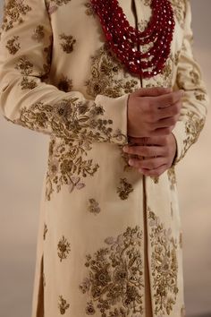 Frosted Almond Sherwani Set | Jatin Malik Introducing our masterpiece: the golden placement hand-embroidered sherwani. This exquisite sherwani showcases an intricate embroidery technique that utilizes various types of dabka and moti, creating a stunning visual impact. Paired with a wine hand-embroidered stole and matching safa, this ensemble epitomizes refined luxury and traditional excellence. Perfect for making a grand and elegant statement, this sherwani set is a testament to exceptional craftsmanship and timeless style. Included in purchase: Sherwani, Kurta, Churidar, Stole, Safa Product Specification Color: Golden Fabric: Linen silk Occasion: Engagement, Wedding, Bridal, Reception Style: Sherwani, Kurta, Churidar, Stole, Safa Care: Dry Clean Work: Hand Embroidery Customization options Manpreet Toor, Jatin Malik, Embroidered Sherwani, Blouse Yoke, Royal Look, Haldi Ceremony, Indian Wedding Outfits, Intricate Embroidery