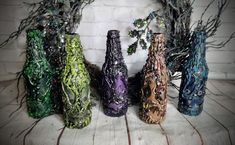 Description: Spooky Bottles for Decorating  Set of 5  Size: 9 H. 3 L. Circle  Color: Abstract Painted Purples, Greens, Blues, Flesh Blood,  Theme: Abstract Spooky Monster Bottles You can use these for floral arrangements, Candle Stick Battery Operated Recommended, Moss, Twigs,   Condition: Newly Designed & Restored  ThanXs For StopPin In ! If you have Any Question Feel Free to Message Me !  All Sales Are Final  No Returns Krazed Dezigns Bringing the Old back to Life ! Or Creating New ! Spooky Halloween Dishes, Diy Halloween Bottles, Wine Sleeve, Halloween Wine Bottles, Wine Bottle Charms, Fake Candles, Halloween Frames