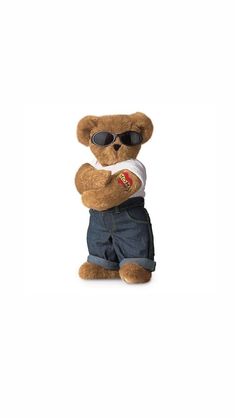 a brown teddy bear wearing sunglasses and denim shorts