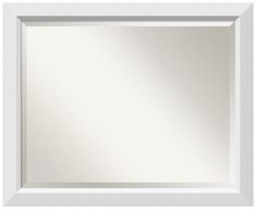 an empty white framed mirror on a white wall with no one in the frame or around it