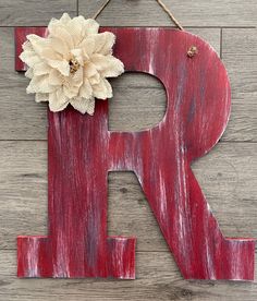 the letter r is painted red and has a flower on it