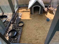 a dog house made out of sand and gravel