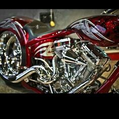 a red and silver motorcycle parked in a garage