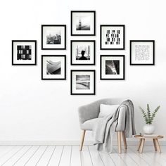 a white room with black and white pictures on the wall, a gray chair and a potted plant