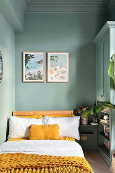 a bedroom with blue walls and yellow bedding