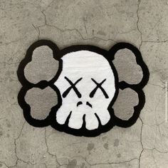 a white and black rug with a skull on it