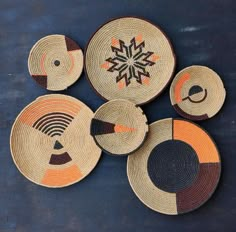 four woven baskets with different designs on them