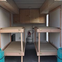 two bunk beds in the back of a truck with no mattresses or covers on them