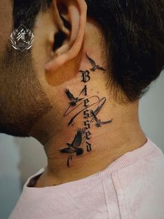 a man with a tattoo on his neck and behind the ear that has birds flying around it