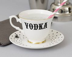 a cup with a straw in it sitting on a saucer next to a napkin