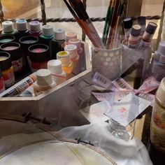 an assortment of crafting supplies sitting on a table