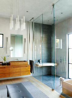 a modern bathroom with wood and glass accents