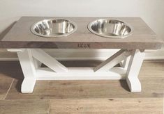 two stainless steel bowls sit on top of a wooden table that is made out of wood