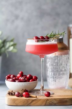 the cranberry martini is garnished with rosemary