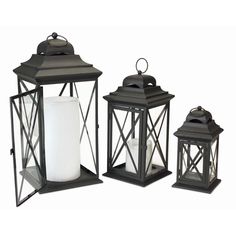 three black lanterns with one white candle