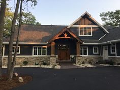 a large house with stone and wood accents