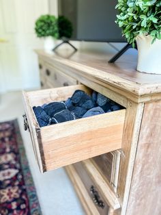 a wooden cabinet with blue rocks in it