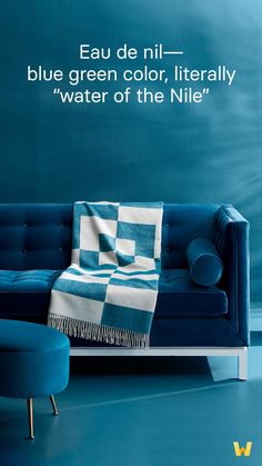 a blue couch sitting in front of a wall with the words eau de nii - blue green color literally water of the nile