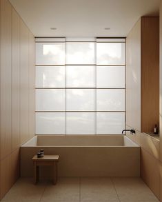 an empty bathroom with a large window above the bathtub