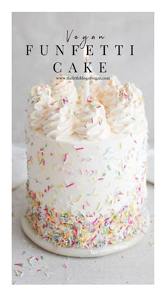 a cake with white frosting and sprinkles on it