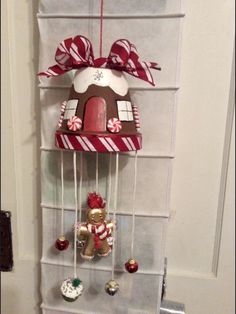 the door is decorated with candy canes and gingerbread house decorations