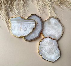 three pieces of white agate with gold trim