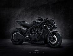 a black motorcycle is parked in the dark