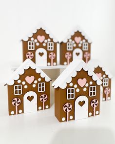 four gingerbread houses with hearts on them