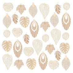 a collection of gold leaf shaped ornaments on a white background