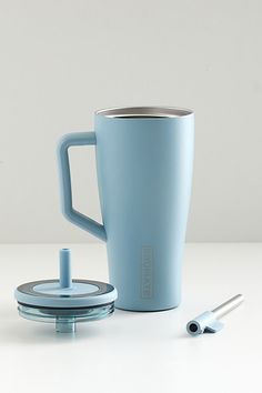 a blue coffee mug next to a cup holder