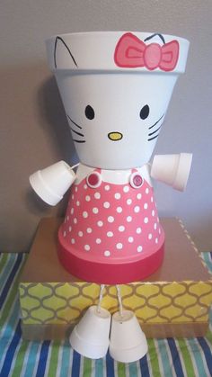 a hello kitty planter sitting on top of a table