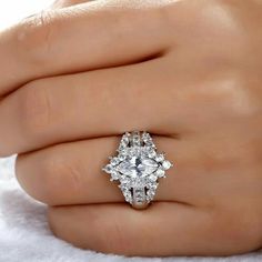 a woman's hand with a diamond ring on it