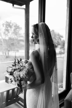 a woman in a wedding dress holding a bouquet