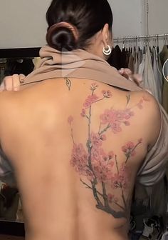 the back of a woman's body with flowers on it